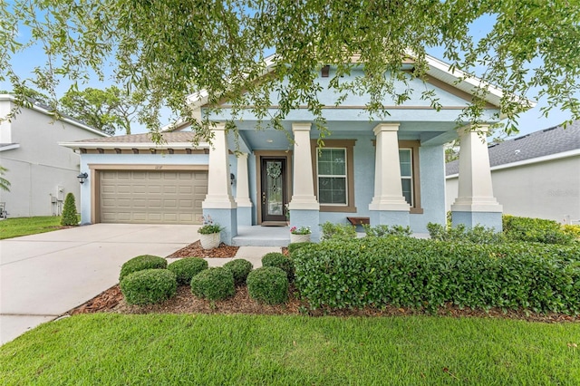 1237 Windy Bay Shl, Tarpon Springs, FL 34689 - greek revival house with concrete driveway, an attached garage, stucco siding, covered porch, and a front yard