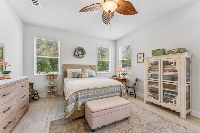 1237 Windy Bay Shl, Tarpon Springs, FL 34689 - bedroom with light wood-style floors and a ceiling fan