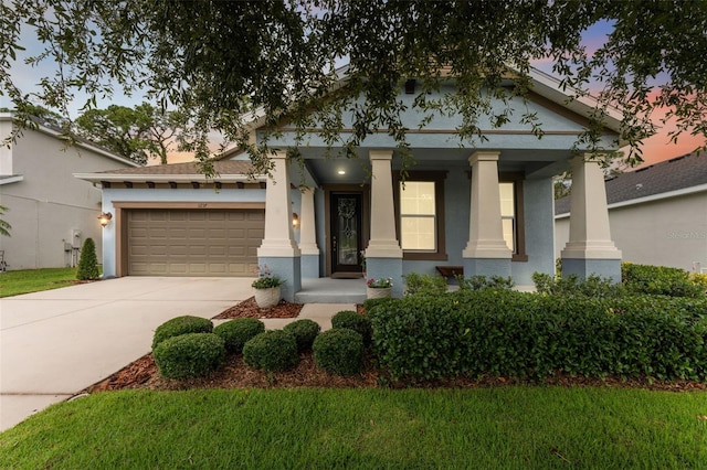 1237 Windy Bay Shl, Tarpon Springs, FL 34689 - greek revival inspired property with stucco siding, driveway, a garage, a porch, and a yard