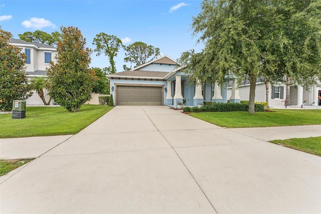 1237 Windy Bay Shl, Tarpon Springs, FL 34689 - view of front of property with a garage, stucco siding, a front lawn, and concrete driveway