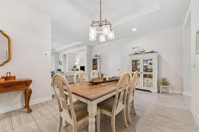 1237 Windy Bay Shl, Tarpon Springs, FL 34689 - dining space with a raised ceiling, a chandelier, and light tile patterned floors