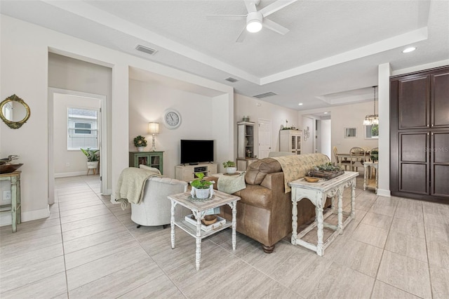 1237 Windy Bay Shl, Tarpon Springs, FL 34689 - living room with ceiling fan, a raised ceiling, recessed lighting, light tile patterned floors, and a chandelier