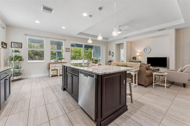 1237 Windy Bay Shl, Tarpon Springs, FL 34689 - kitchen with dishwasher, a textured ceiling, a tray ceiling, a breakfast bar, and open floor plan