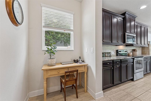 1237 Windy Bay Shl, Tarpon Springs, FL 34689 - kitchen with stainless steel appliances, backsplash, an office area, recessed lighting, and light stone counters