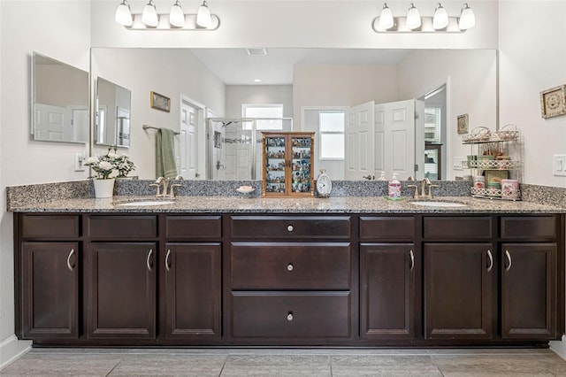 1237 Windy Bay Shl, Tarpon Springs, FL 34689 - bathroom featuring a shower stall and double vanity