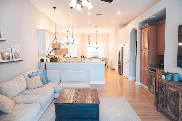 6804 Pleasant Oaks Pl, Riverview, FL 33578 - living area featuring wine cooler, light wood finished floors, a chandelier, ceiling fan, and recessed lighting