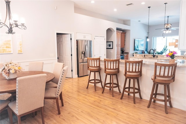 6804 Pleasant Oaks Pl, Riverview, FL 33578 - dining area featuring light wood-type flooring, a ceiling fan, a chandelier, recessed lighting, and arched walkways