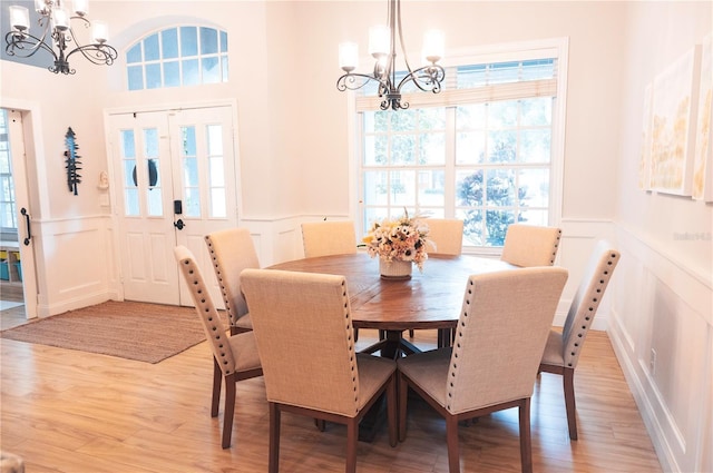 6804 Pleasant Oaks Pl, Riverview, FL 33578 - dining space featuring a chandelier, a decorative wall, a wainscoted wall, and light wood finished floors