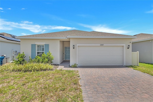 2359 White Cedar Way, Haines City, FL 33844 - ranch-style house with decorative driveway, a garage, stucco siding, and roof with shingles