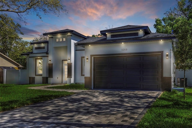 1213 E Lemon St, Tarpon Springs, FL 34689 - view of front of property featuring an attached garage, stucco siding, driveway, and a yard
