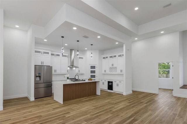 1213 E Lemon St, Tarpon Springs, FL 34689 - kitchen with stainless steel refrigerator with ice dispenser, beverage cooler, wall chimney exhaust hood, recessed lighting, and light wood-type flooring