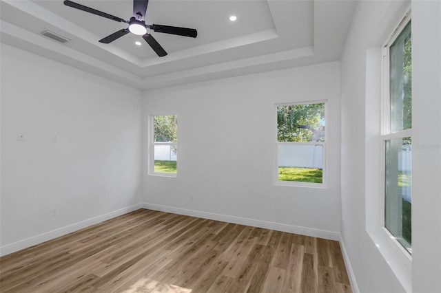 1213 E Lemon St, Tarpon Springs, FL 34689 - unfurnished room featuring plenty of natural light, light wood-style floors, a tray ceiling, recessed lighting, and ceiling fan