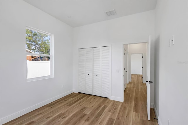 1213 E Lemon St, Tarpon Springs, FL 34689 - unfurnished bedroom with light wood finished floors and a closet