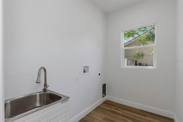 1213 E Lemon St, Tarpon Springs, FL 34689 - laundry area with hookup for an electric dryer, hookup for a washing machine, and wood finished floors