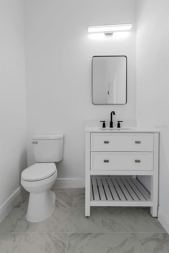 1213 E Lemon St, Tarpon Springs, FL 34689 - bathroom featuring marble look tile flooring and vanity