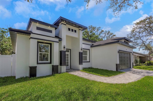 1213 E Lemon St, Tarpon Springs, FL 34689 - view of front of house with stucco siding, a garage, and driveway