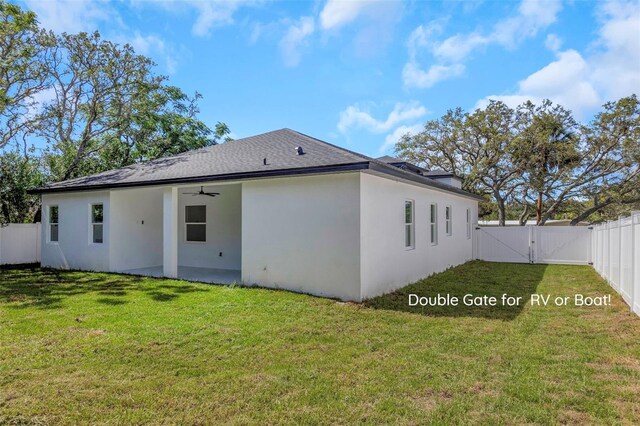 1213 E Lemon St, Tarpon Springs, FL 34689 - back of property featuring a gate, ceiling fan, stucco siding, and a fenced backyard