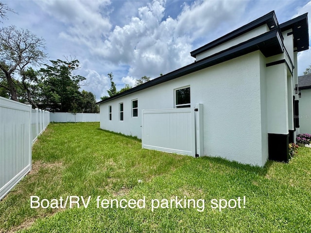 1213 E Lemon St, Tarpon Springs, FL 34689 - rear view of house featuring stucco siding