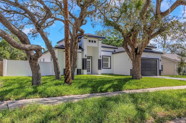 1213 E Lemon St, Tarpon Springs, FL 34689 - view of front facade featuring stucco siding, a garage, and concrete driveway