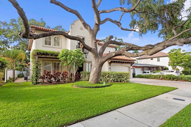 3307 W Knights Ave, Tampa, FL 33611 - mediterranean / spanish-style house featuring concrete driveway, stucco siding, a tiled roof, and an attached garage