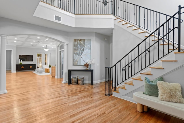 3307 W Knights Ave, Tampa, FL 33611 - stairway with decorative columns, wood finished floors, arched walkways, recessed lighting, and a high ceiling