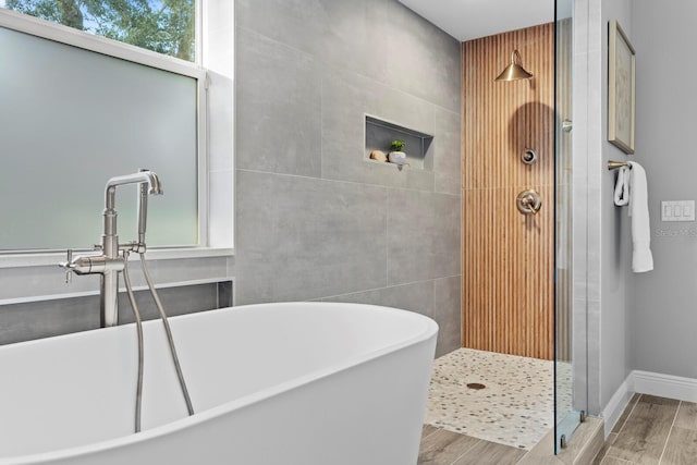 3307 W Knights Ave, Tampa, FL 33611 - full bath with wood finished floors, a freestanding tub, and a tile shower