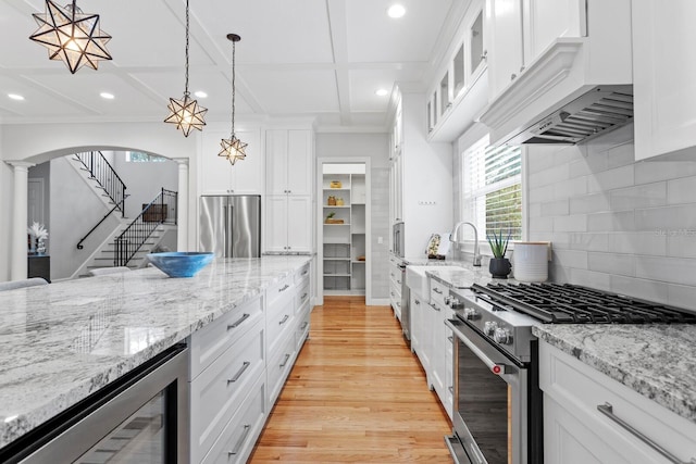 3307 W Knights Ave, Tampa, FL 33611 - kitchen featuring high end appliances, recessed lighting, range hood, wine cooler, and light wood-style floors