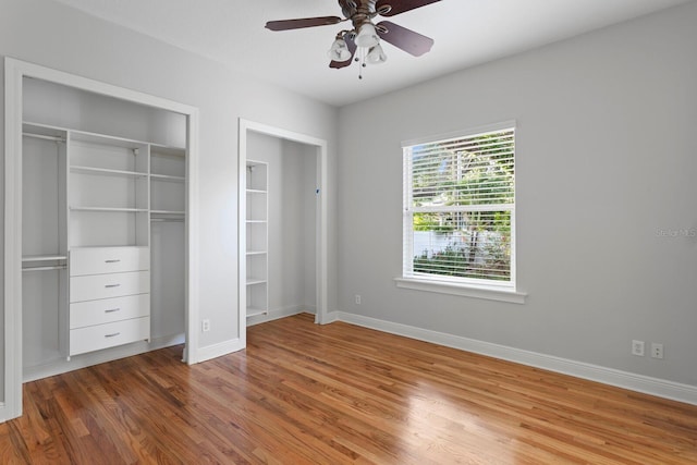 3307 W Knights Ave, Tampa, FL 33611 - unfurnished bedroom featuring two closets, wood finished floors, and ceiling fan