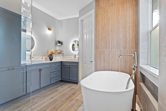 3307 W Knights Ave, Tampa, FL 33611 - full bath featuring double vanity, a soaking tub, and wood finished floors
