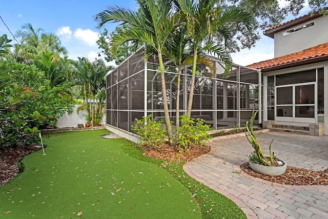 3307 W Knights Ave, Tampa, FL 33611 - view of yard with an area to practice putting, a patio, and a lanai