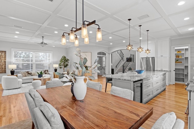 3307 W Knights Ave, Tampa, FL 33611 - dining area featuring coffered ceiling, wine cooler, stairs, light wood-type flooring, and recessed lighting