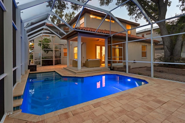 3307 W Knights Ave, Tampa, FL 33611 - back of property featuring a tile roof, a lanai, a patio, and stucco siding