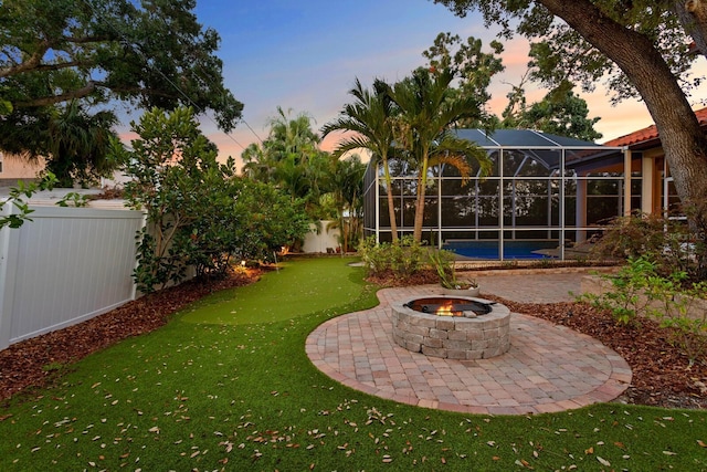 3307 W Knights Ave, Tampa, FL 33611 - fenced backyard with an outdoor fire pit, a patio area, and glass enclosure