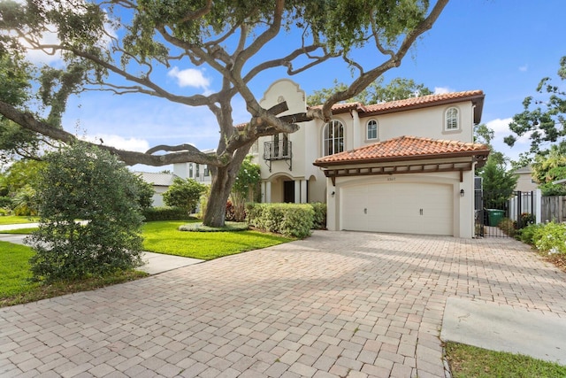 3307 W Knights Ave, Tampa, FL 33611 - view of front of house featuring stucco siding, a garage, decorative driveway, and a tiled roof
