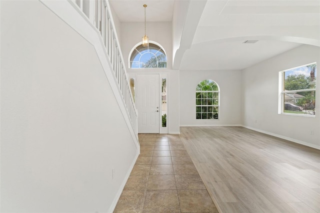 3013 Silvermill Loop Unit O, Land O Lakes, FL 34638 - foyer with plenty of natural light, a chandelier, stairway, and light tile patterned flooring
