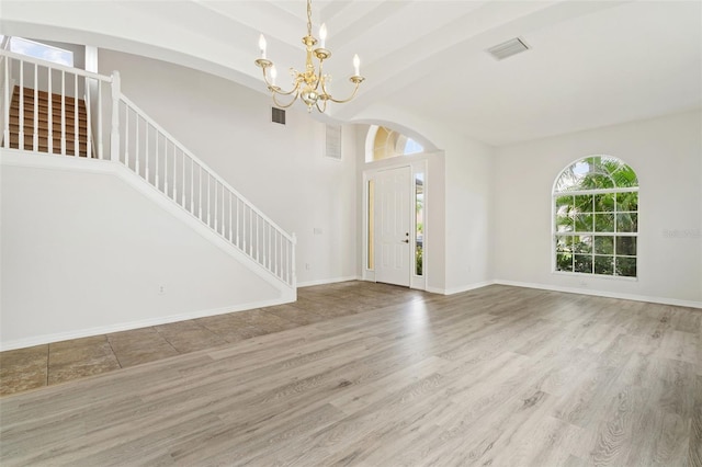 3013 Silvermill Loop Unit O, Land O Lakes, FL 34638 - foyer entrance featuring stairway, a chandelier, wood finished floors, and arched walkways
