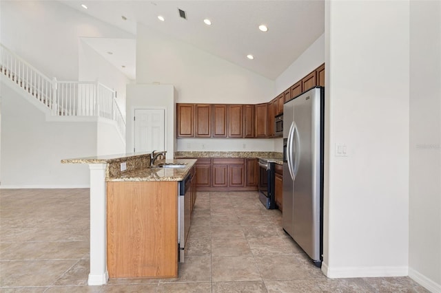 3013 Silvermill Loop Unit O, Land O Lakes, FL 34638 - kitchen featuring appliances with stainless steel finishes, light stone countertops, recessed lighting, high vaulted ceiling, and an island with sink