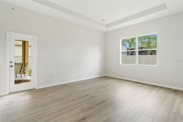 3013 Silvermill Loop Unit O, Land O Lakes, FL 34638 - empty room featuring light wood-style floors and a tray ceiling
