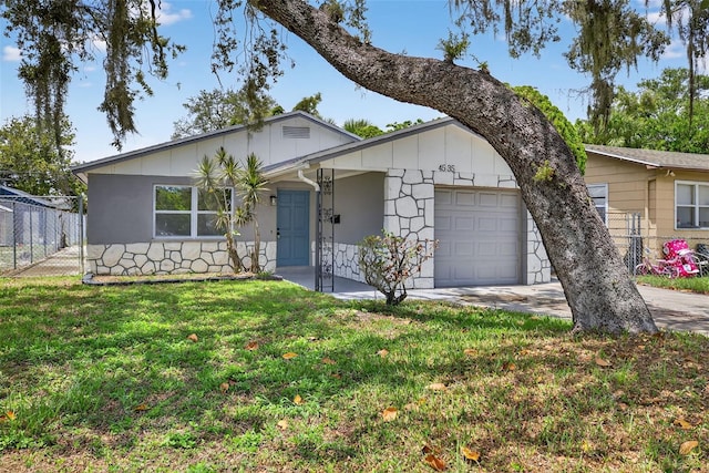 4535 15th Ave S, Saint Petersburg, FL 33711 - ranch-style home with a garage, board and batten siding, concrete driveway, and stone siding