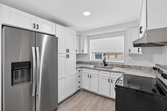 4535 15th Ave S, Saint Petersburg, FL 33711 - kitchen featuring stainless steel appliances, extractor fan, white cabinetry, light wood-style floors, and recessed lighting