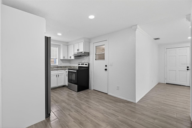4535 15th Ave S, Saint Petersburg, FL 33711 - kitchen with electric range, white cabinetry, recessed lighting, light wood-style floors, and under cabinet range hood