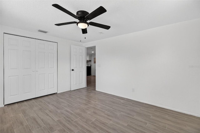 4535 15th Ave S, Saint Petersburg, FL 33711 - unfurnished bedroom with light wood finished floors, a closet, and a ceiling fan