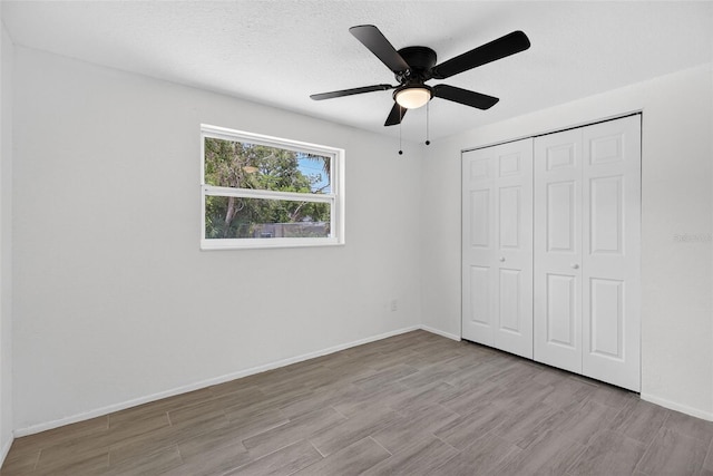 4535 15th Ave S, Saint Petersburg, FL 33711 - unfurnished bedroom featuring wood finished floors, a closet, and a ceiling fan