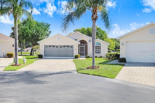 4407 Whitton Way, New Port Richey, FL 34653 - ranch-style home with driveway, stucco siding, and a front lawn