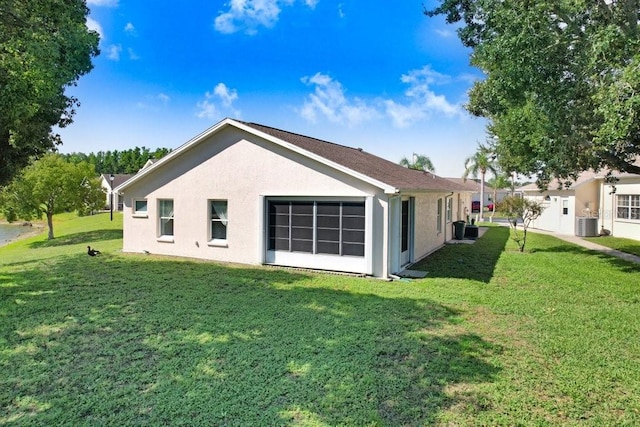 4407 Whitton Way, New Port Richey, FL 34653 - back of property featuring a lawn and stucco siding