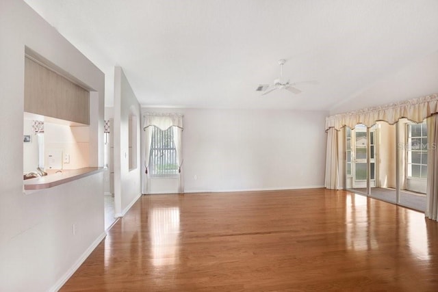 4407 Whitton Way, New Port Richey, FL 34653 - empty room with ceiling fan, wood finished floors, and lofted ceiling