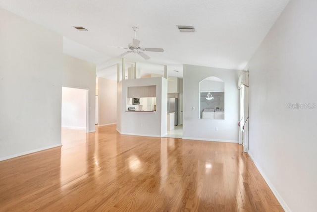 4407 Whitton Way, New Port Richey, FL 34653 - unfurnished living room featuring lofted ceiling, a ceiling fan, and light wood finished floors