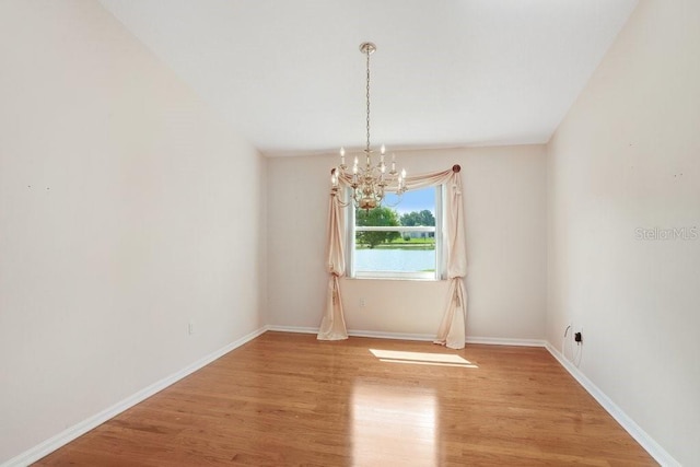 4407 Whitton Way, New Port Richey, FL 34653 - unfurnished room with a chandelier and light wood-style floors