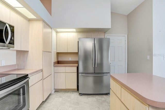 4407 Whitton Way, New Port Richey, FL 34653 - kitchen featuring stainless steel appliances, light countertops, light brown cabinetry, and tasteful backsplash