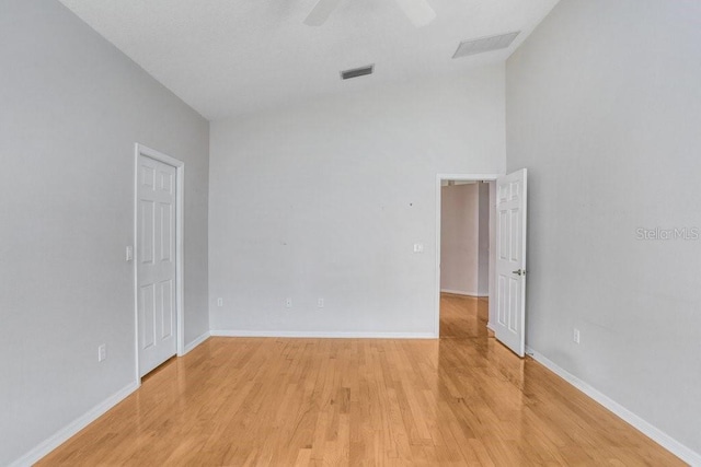 4407 Whitton Way, New Port Richey, FL 34653 - empty room featuring light wood-style flooring, vaulted ceiling, and a ceiling fan